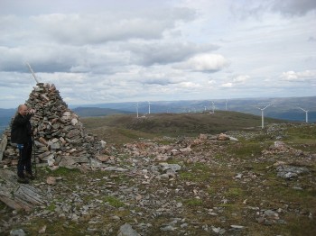 Andy at the large summit cairn of Meall Dubh